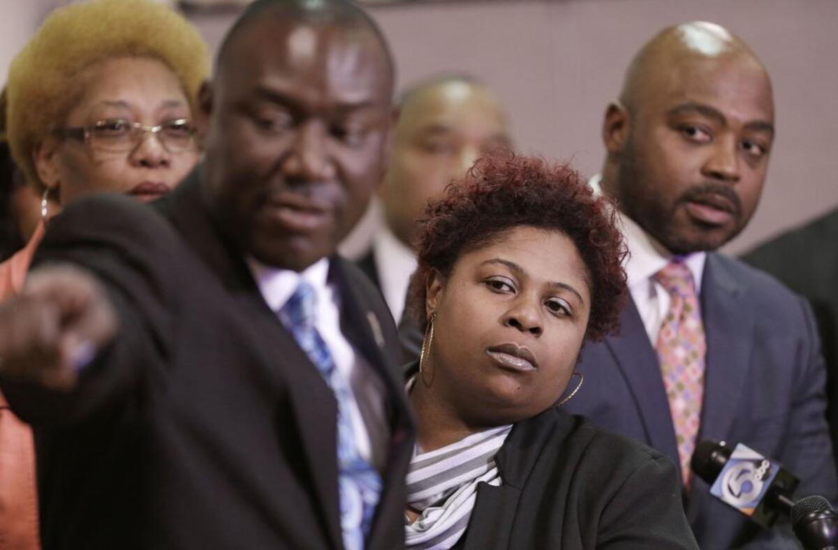 Samaria Rice, center, the mother of Tamir Rice, a 12-year-old boy fatally shot by a Cleveland police officer, watches the video of Tamir’s shooting during a March 2015 news-conference in Cleveland. Attorney Benjamin Crump, left, and attorneys Walter Madison, right, also watch.