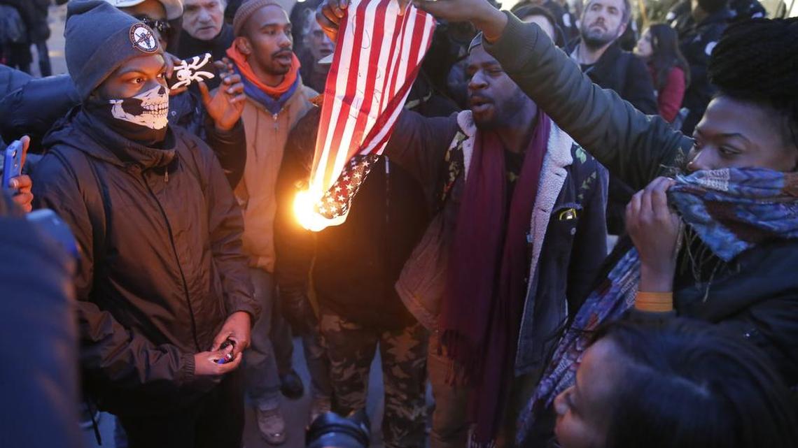 Protesters burn an American flag in Chicago on Feb. 23, 2016. A North Carolina history teacher who reportedly “stomped” on a U.S. flag during a lesson about freedom of speech says he has been suspended.