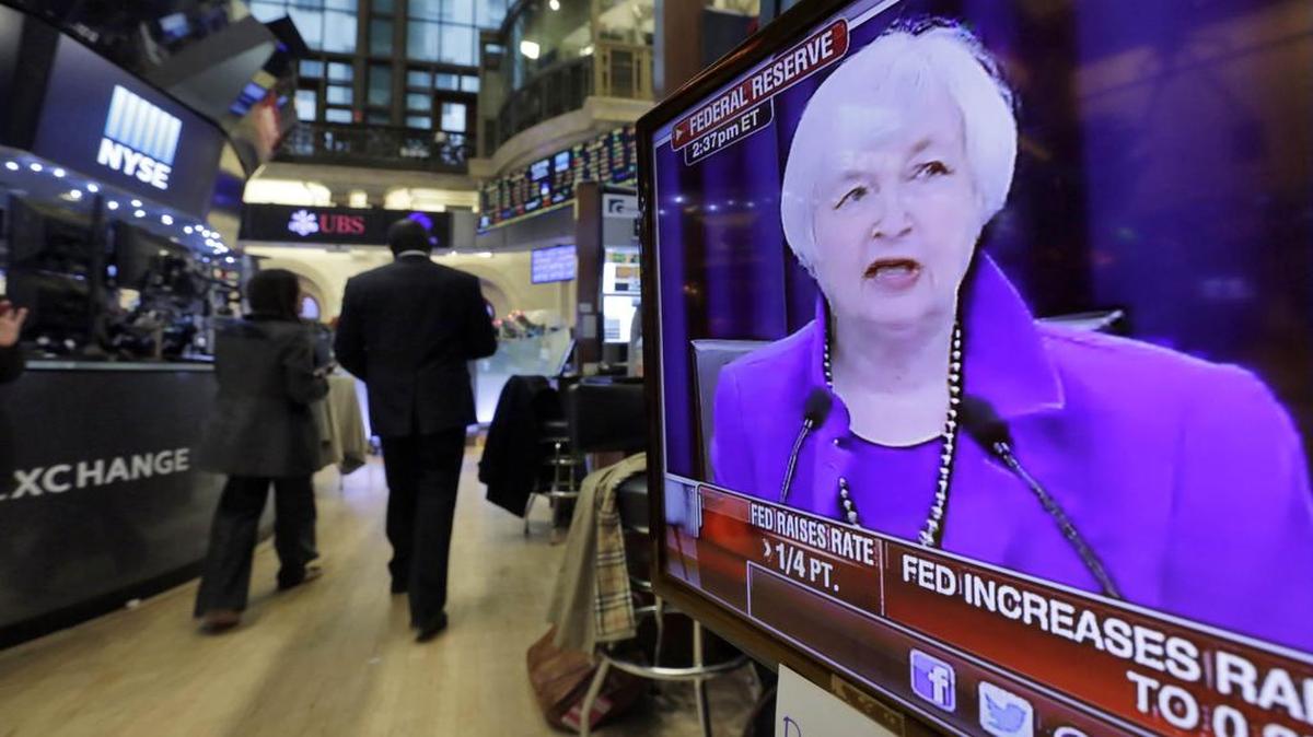 Federal Reserve Chair Janet Yellen’s Washington news conference is shown on a television screen on the floor of the New York Stock Exchange, Wednesday, Dec. 16, 2015. The Fed’s move to lift its key rate by a quarter-point to a range of 0.25 percent to 0.5 percent ends an extraordinary seven-year period of near-zero rates that began at the depths of the 2008 financial crisis.