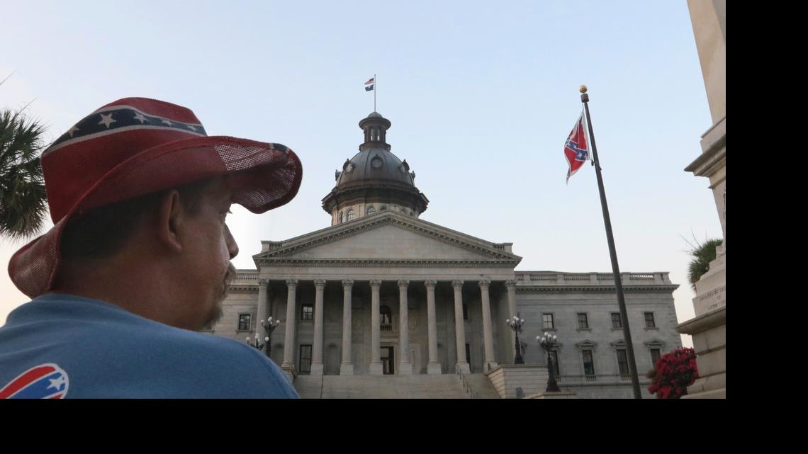 
John Blankenship drove four hours from Granite Falls, NC, to see the Confederate flag come down from the South Carolina State House grounds. He said he doesn't agree but if it's going to help everyone get along, then take it down.

