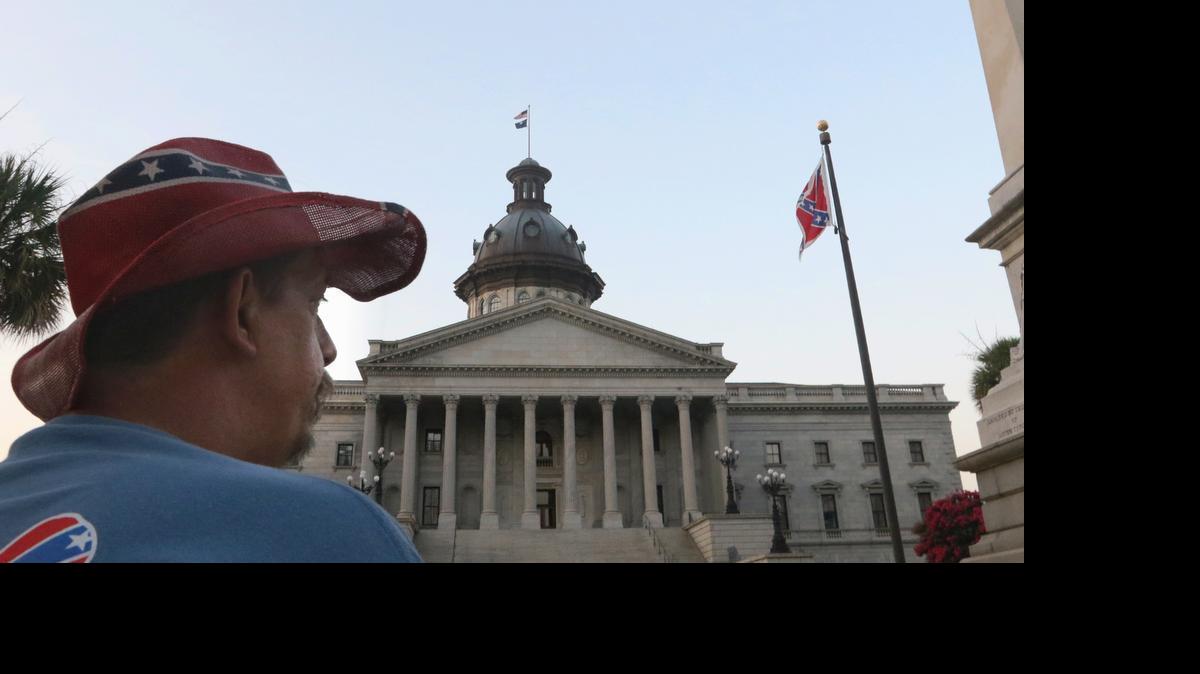 
John Blankenship drove four hours from Granite Falls, NC, to see the Confederate flag come down from the South Carolina State House grounds. He said he doesn't agree but if it's going to help everyone get along, then take it down.

