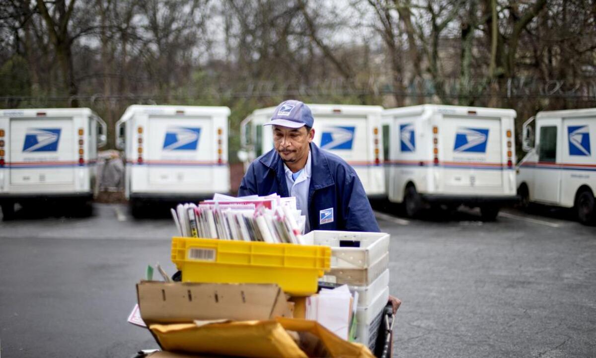 A U.S. Postal Service carrier gathers mail to load into his truck before making his delivery run in Atlanta on February 7, 2013.