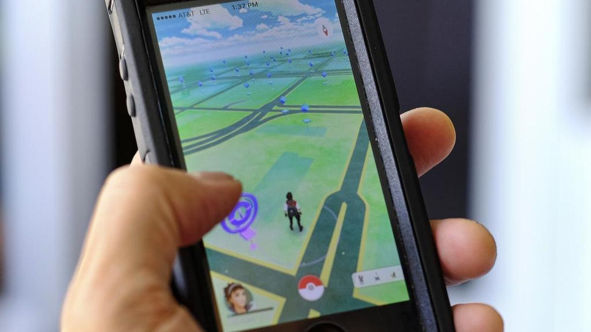 Pokemon Go is displayed on a cell phone in Los Angeles on Friday. Just days after being made available in the U.S., the mobile game Pokemon Go has jumped to become the top-grossing app in the App Store. And players have reported wiping out in a variety of ways as they wander the real world, eyes glued to their smartphone screens, in search of digital monsters.
