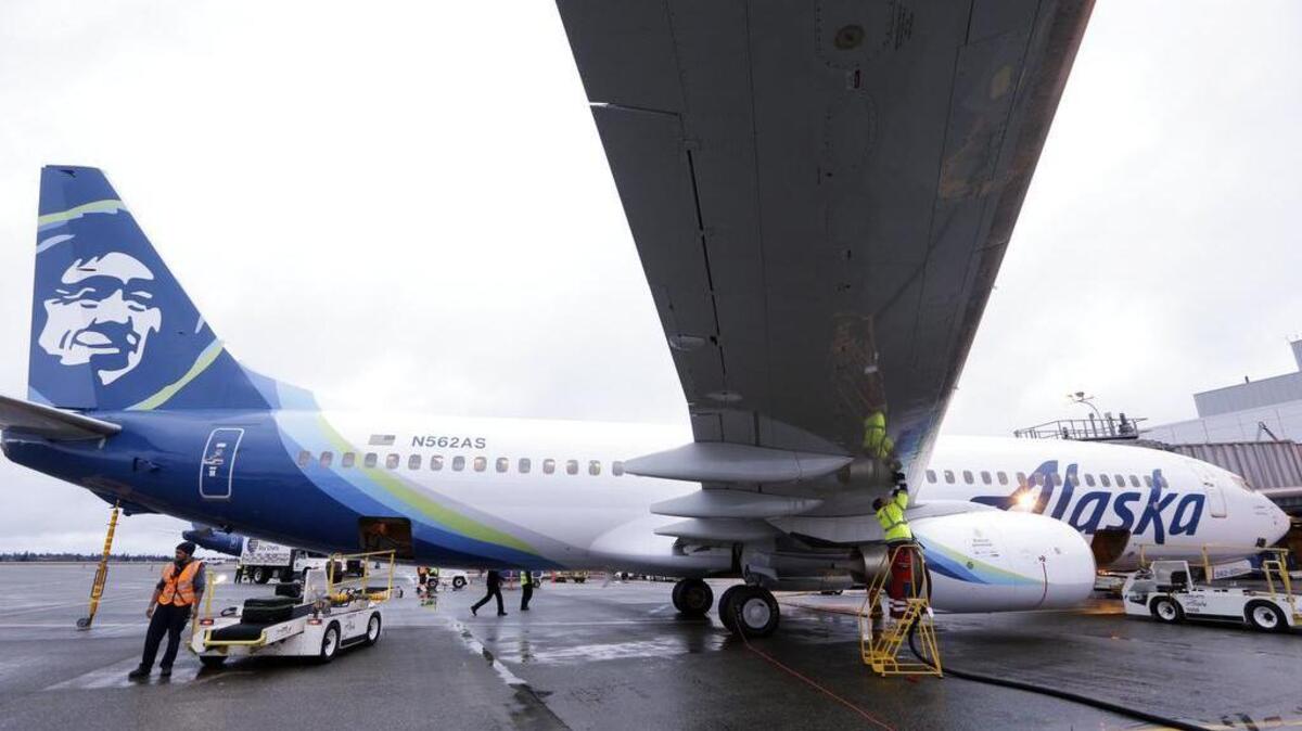 An Alaska Airlines flight from Anchorage to Seattle was forced to turn around Wednesday when a naked man barricaded himself in a bathroom.