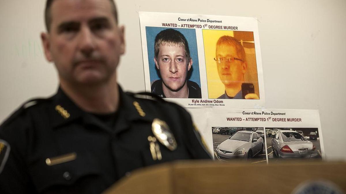 Coeur d'Alene Police Chief Lee White speaks during a news conference Monday, March 7, 2016, with a photo of Kyle Andrew Odom in the background in Coeur D'Alene, Idaho. An Idaho pastor who led the prayer at a weekend campaign rally for Republican presidential candidate Ted Cruz was gunned down outside his church the following day but was expected to survive.