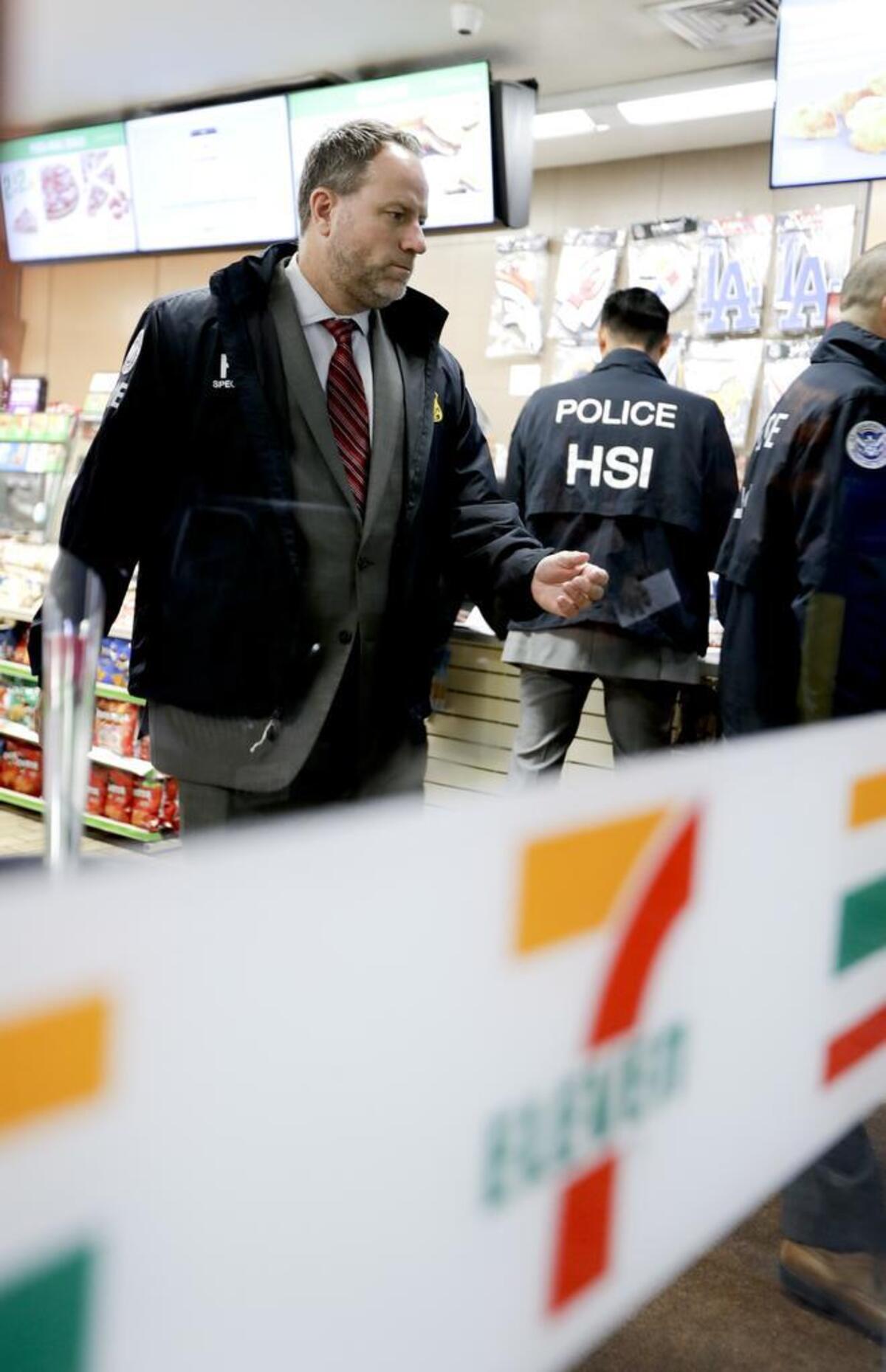 Christopher Kuemmerle, a group supervisor for U.S. immigration and Customs Enforcement’s Homeland Security Investigations unit, watches as agents serve an employment audit notice at a 7-Eleven convenience store Wednesday, Jan. 10, 2018, in Los Angeles. Agents said they targeted about 100 7-Eleven stores nationwide Wednesday to open employment audits and interview workers.