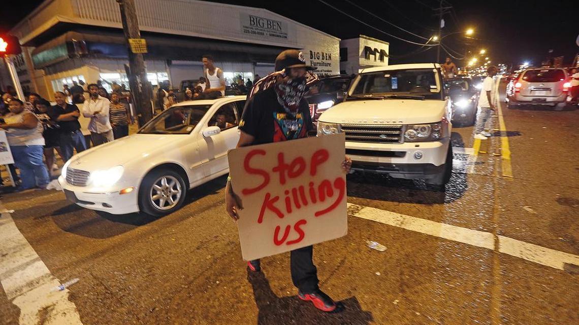 Protestors congregate at N. Foster Dr. and Fairfields Ave., the location of the Triple S convenience store in Baton Rouge, La., on Wednesday. Alton Sterling, 37, was shot and killed outside the store by Baton Rouge police, where he was selling CDs.