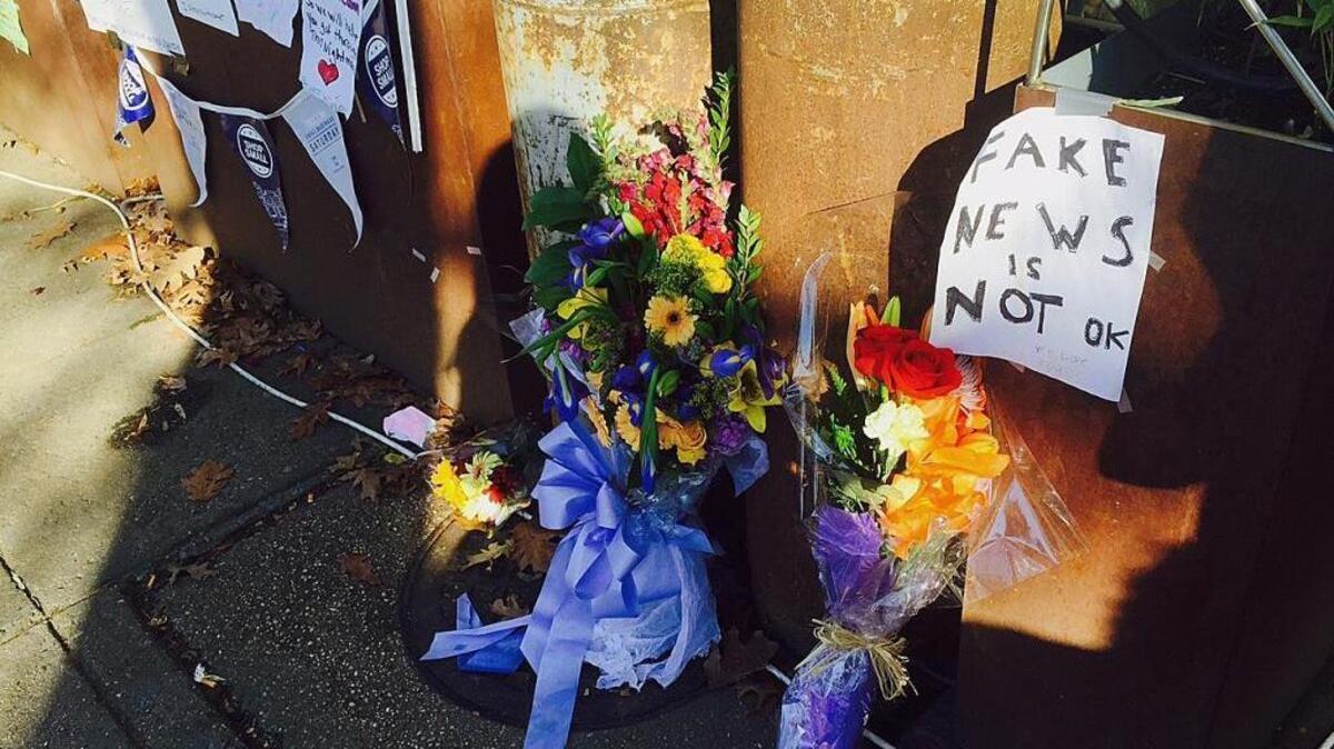 Flowers and notes left by well-wishers are displayed on Dec. 9 outside Comet Ping Pong, the pizza restaurant in Washington. The pizza restaurant in the nation’s capital was the target of fake news stories linking it to a child sex trafficking ring, prompting an armed man to arrive at Comet Ping Pong to investigate the conspiracy and fire several shots into the restaurant.