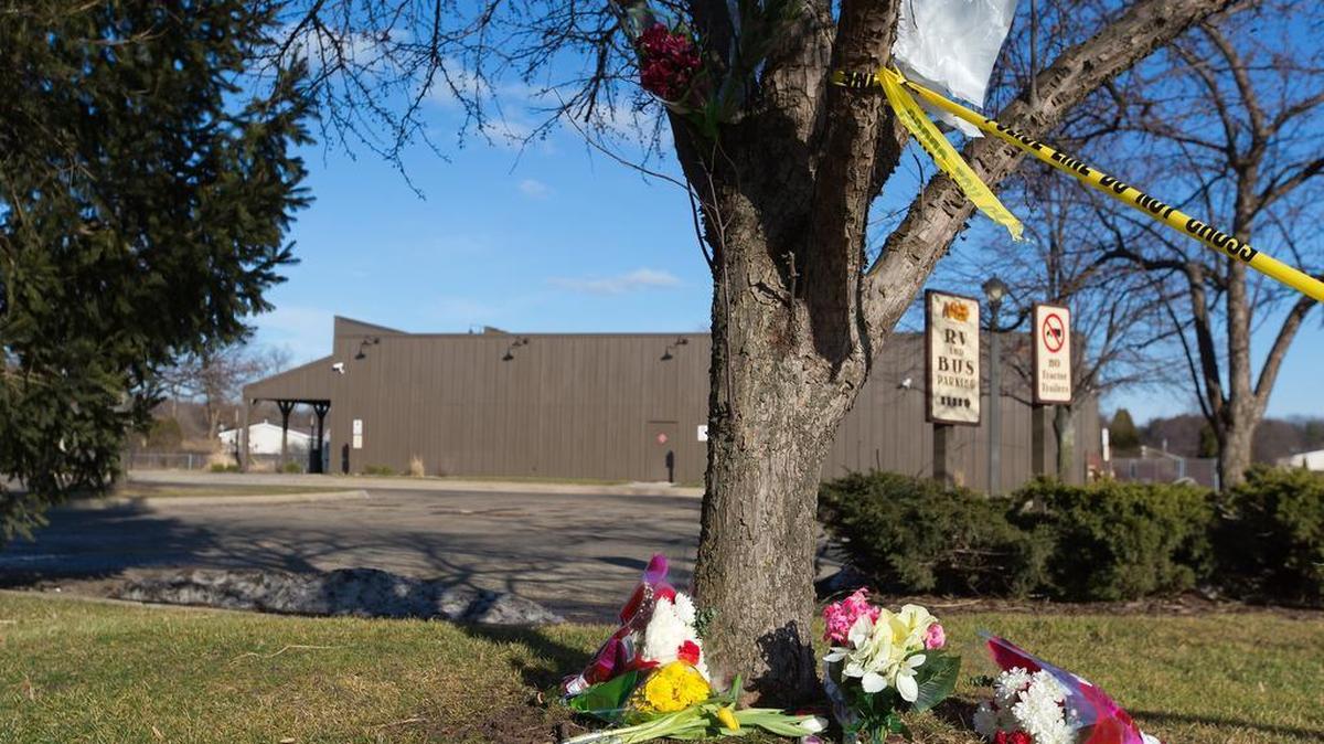 Flowers lie near a makeshift memorial outside a Cracker Barrel restaurant on Sunday, Feb. 21, 2016, in Kalamazoo, Mich. According to police a man drove around Kalamazoo fatally shooting several people at multiple locations on Saturday, including the parking lot of the restaurant.