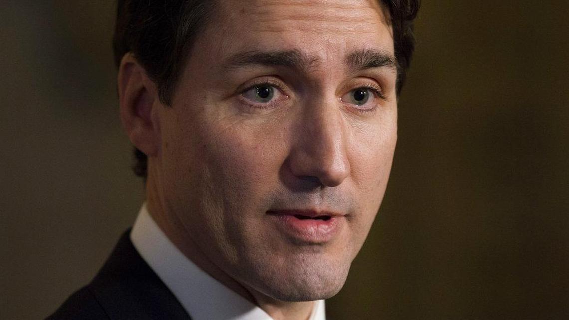 Prime Minister Justin Trudeau speaks with the media in the foyer of the House of Commons in December.