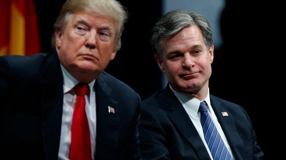 President Donald Trump sits with FBI Director Christopher Wray during the FBI National Academy graduation ceremony on Friday, in Quantico, Va.