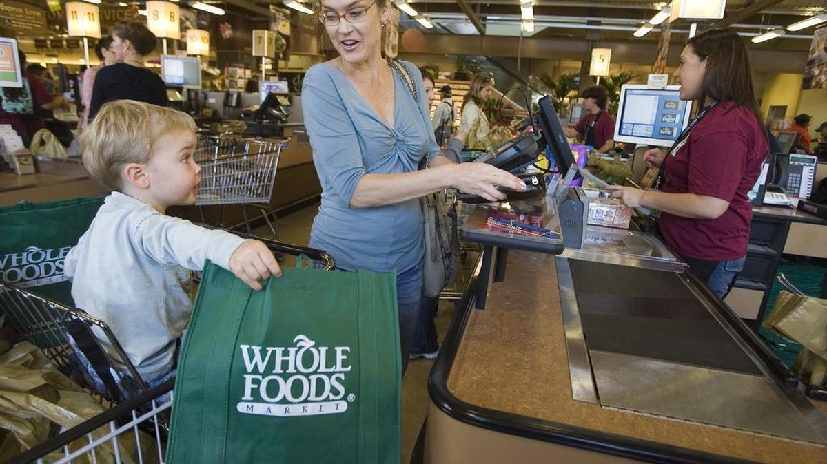 Customers Pam King and her son Rhys, 2, shop for organic groceries at Whole Foods Market Arroyo Parkway store in Pasadena, Calif. in this Nov. 7, 2007 file photo. While Whole Foods led the organic food craze in the U.S., mainstream grocery chains have jumped on board as more and more people began buying organic.