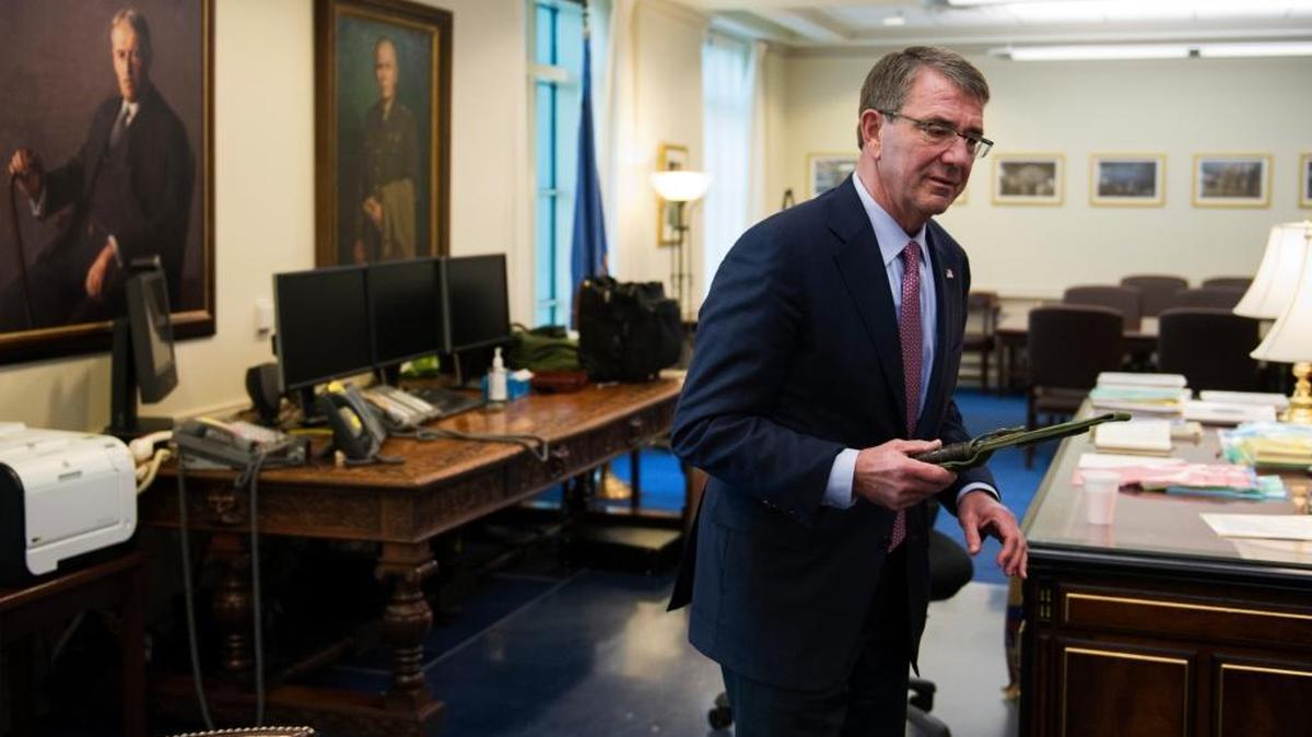 Secretary of Defense Ash Carter holds a Marine Corps Ka-Bar fighting knife while being interviewed in his Pentagon office, Jan. 18, 2017.