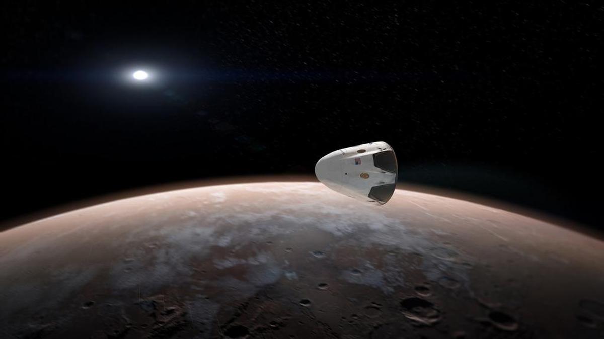 An artist rendering of SpaceX’s Dragon spacecraft approaching Mars.