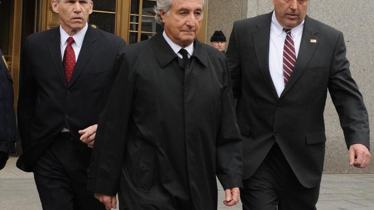 In this March 10, 2009, file photo, Bernard Madoff exits Manhattan federal court in New York. Federal regulators reached a settlement with Madoff on June 16, 2009, that prohibits him from working in the securities industry.