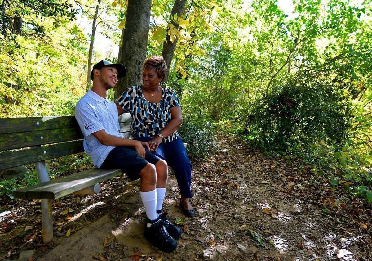 Chancellor Lee Adams, left and his grandmother Saundra Adams sit at Freedom Park in Charlotte in early November 2017. Adams has raised her grandson since birth. He calls her “G-Mom.”