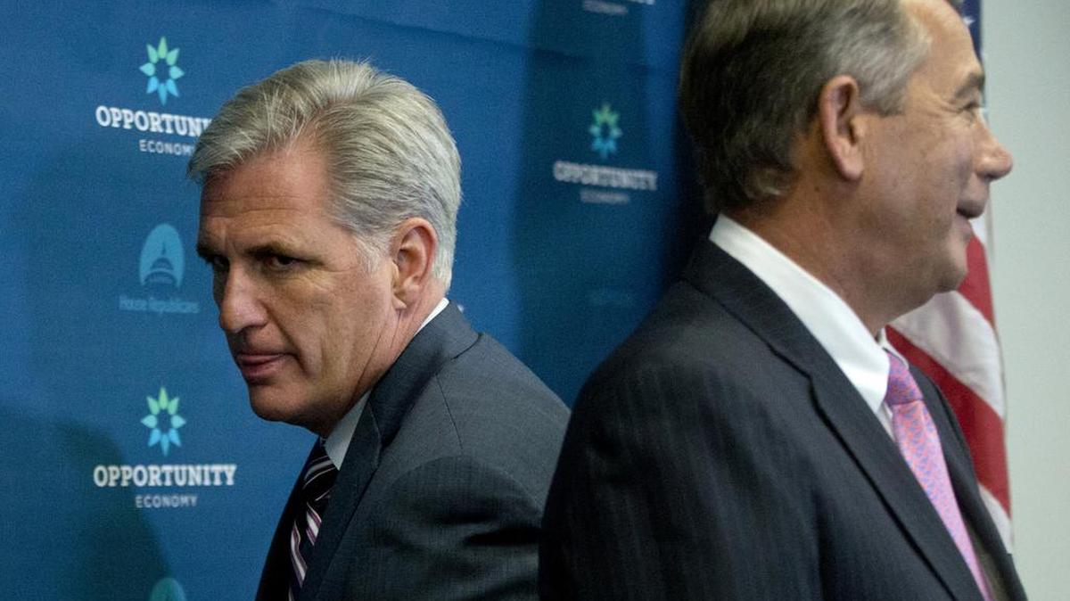 
House Majority Leader Kevin McCarthy of California squeezes behind outgoing Speaker John Boehner of Ohio at the start of a news conference Tuesday on Capitol Hill.

