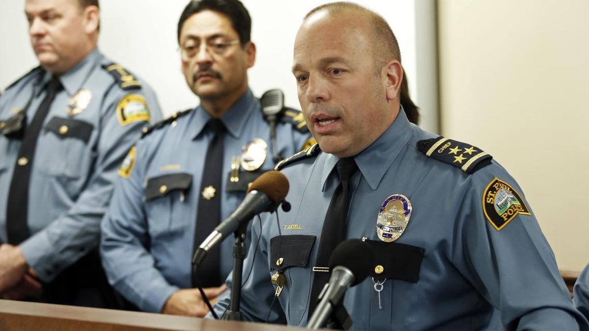 Police Chief Todd Axtell, right, answers questions during a news conference Friday in St. Paul, Minn. Two police officers in Minnesota have been disciplined for a June incident in which a black man was kicked by an officer and bitten by a police dog, St. Paul's police chief said Friday as he released video of the confrontation.