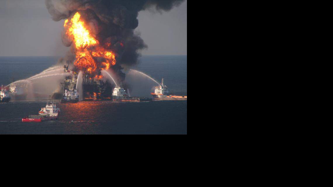 
Fire boat response crews battle the blazing remnants of the off shore oil rig Deepwater Horizon April 21, 2010. A Coast Guard MH-65C dolphin rescue helicopter and crew document the fire aboard the mobile offshore drilling unit Deepwater Horizon, while searching for survivors April 21, 2010. Multiple Coast Guard helicopters, planes and cutters responded to rescue the Deepwater Horizon's 126 person crew. 
