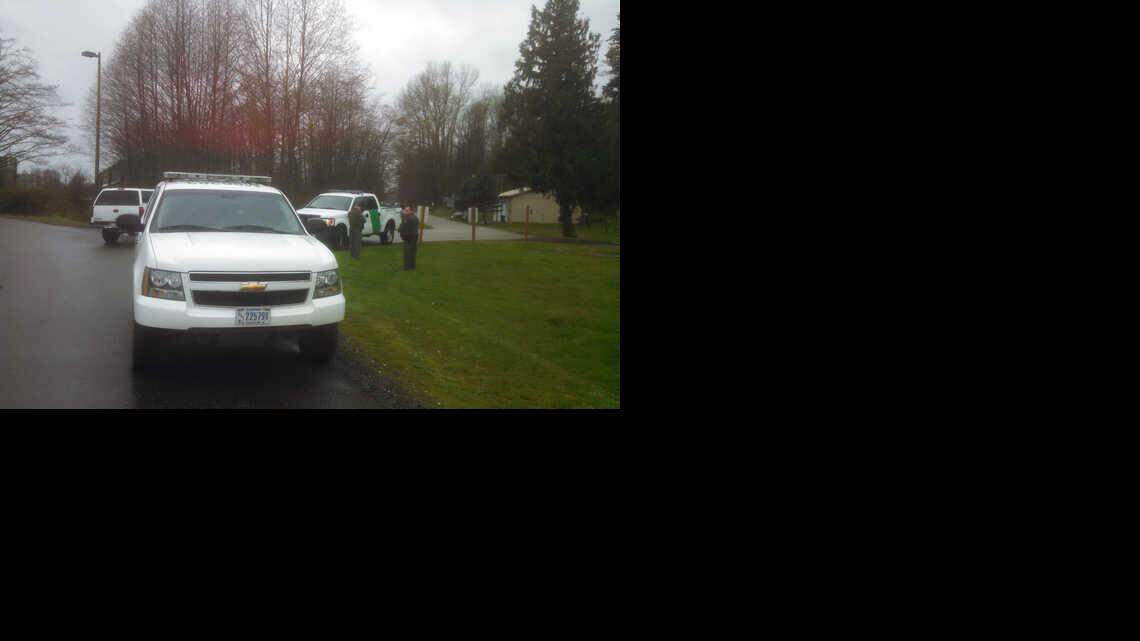 
The U.S. Border Patrol sets up road blocks at Kneuman Road just west of Sumas Thursday, March 19, 2015 after a man was shot and killed. 
