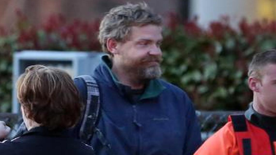 
Louis Jordan, second from left, walks from the Coast Guard helicopter to the Sentara Norfolk General Hospital in Norfolk, Va., after being found off the North Carolina coast, April 2, 2015. His family says he sailed out of a marina in Conway, S.C., on Jan. 23, and hadn't been heard from since.
