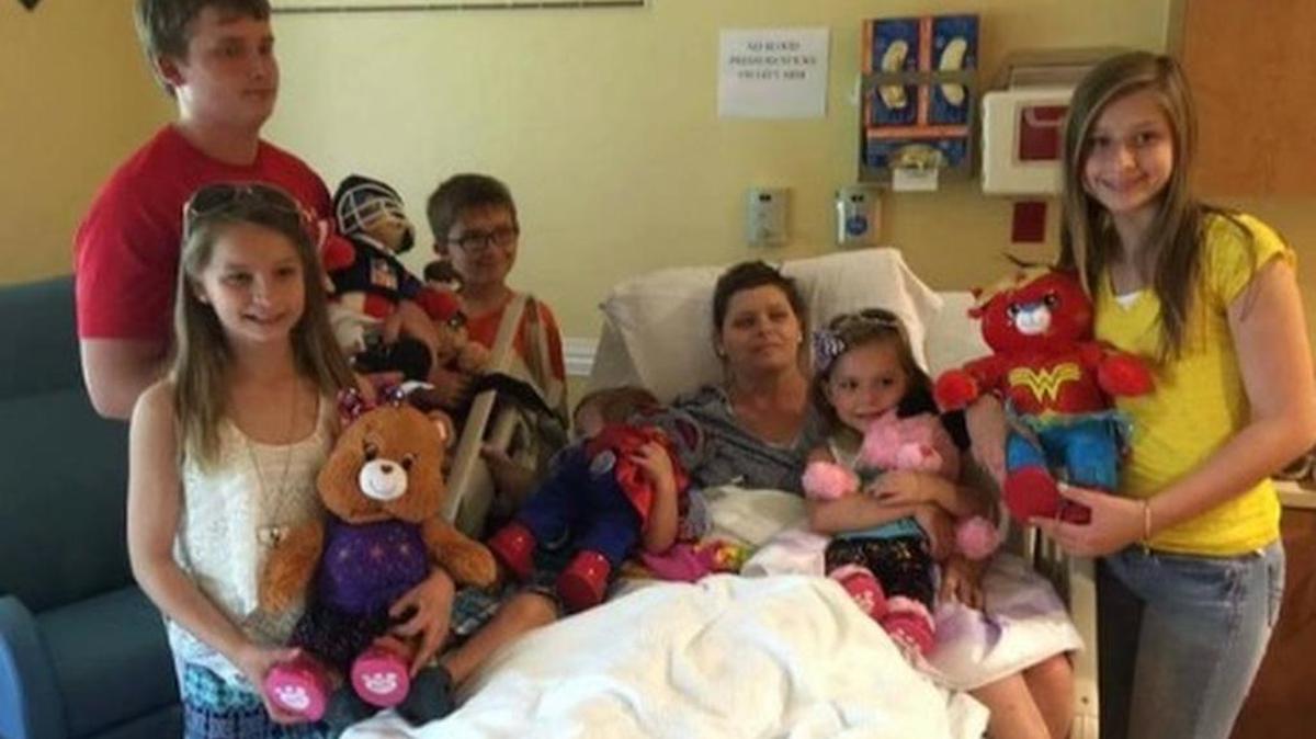 Beth Laitkep is surrounded by her six children.