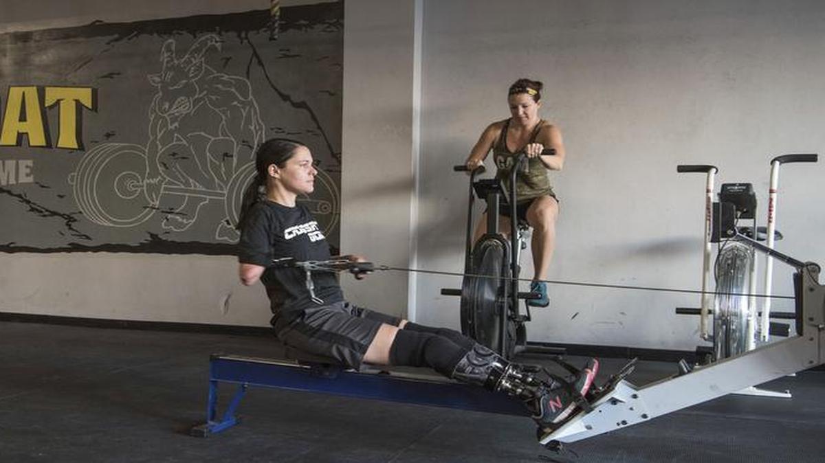 Marine veteran Cindy Martinez warms up on a rowing machine ahead of a weightlifting workout at the Crossfit Goat gym in Dacula, Georgia. Martinez lost three limbs and part of the fingers on her remaining arm after getting a flesh-eating bacteria in 2015 and nearly dying.