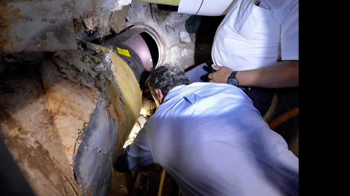 
This photo provided by New York State Governor's office shows Gov. Andrew Cuomo looking at the area where two convicted murderers used power tools to cut through steel pipes at a maximum-security prison in Dannemora, NY, near the Canadian border and escaped through a manhole, New York. Cuomo said Saturday, June 6, 2015, that Richard Matt, 48, and David Sweat, 34, "are two dangerous individuals." 
