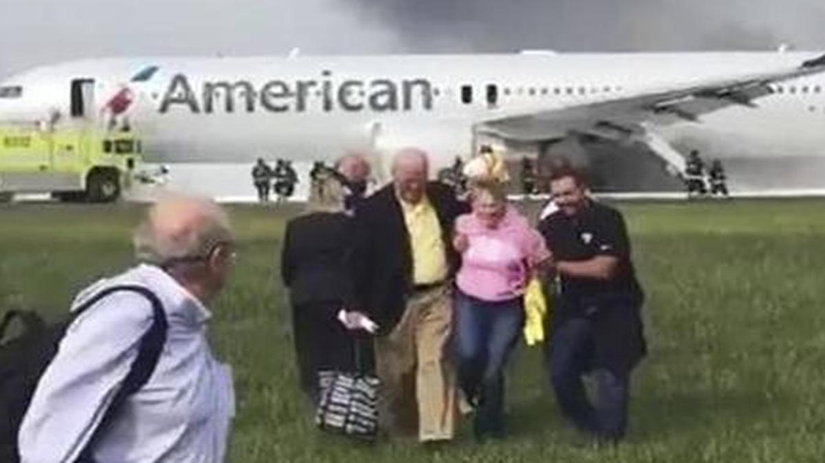 In this photo provided by passenger Jose Castillo, fellow passengers walk away from a burning American Airlines jet that aborted takeoff and caught fire on the runway at Chicago's O'Hare International Airport on Friday. Pilots on Flight 383 bound for Miami reported an engine-related mechanical issue, according to an airline spokeswoman.
