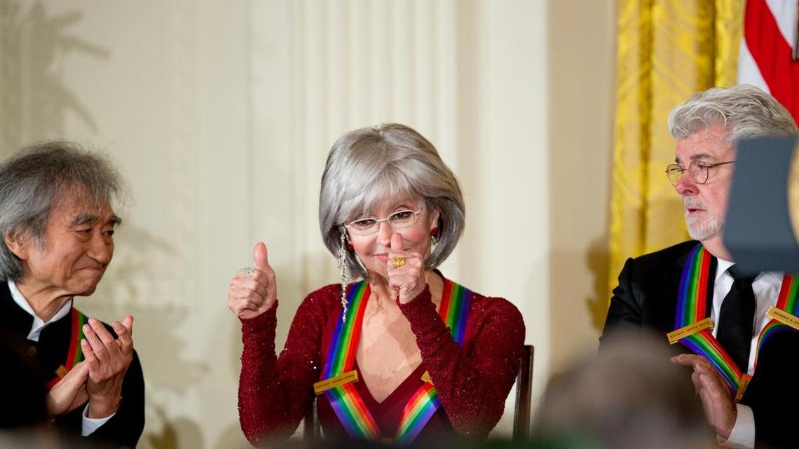 2015 Kennedy Center Honors honorees from left, conductor Seiji Ozawa, actress and singer Rita Moreno, and filmmaker George Lucas on stage at the 2015 Kennedy Center Honors reception in the East Room of the White House on Sunday. The 2015 Kennedy Center Honors Honorees are singer-songwriter Carole King, filmmaker George Lucas, actress and singer Rita Moreno, conductor Seiji Ozawa, and actress Cicely Tyson.