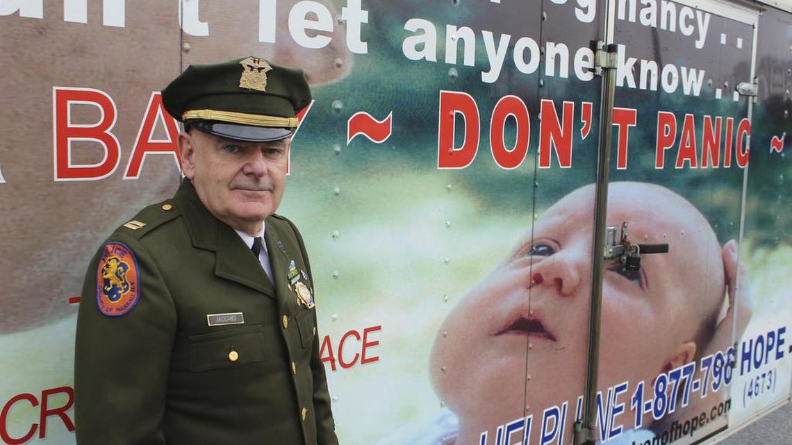 Timothy Jaccard stands in front of a trailer in Wantagh, N.Y., that advertises a hotline where mothers can call to arrange to safely relinquish babies they are unwilling or unable to care for, to a responsible party. The retired ambulance medic lobbied legislatures across the country to pass so-called "Safe Haven" laws in all 50 states. (AP Photo/Frank Eltman)
