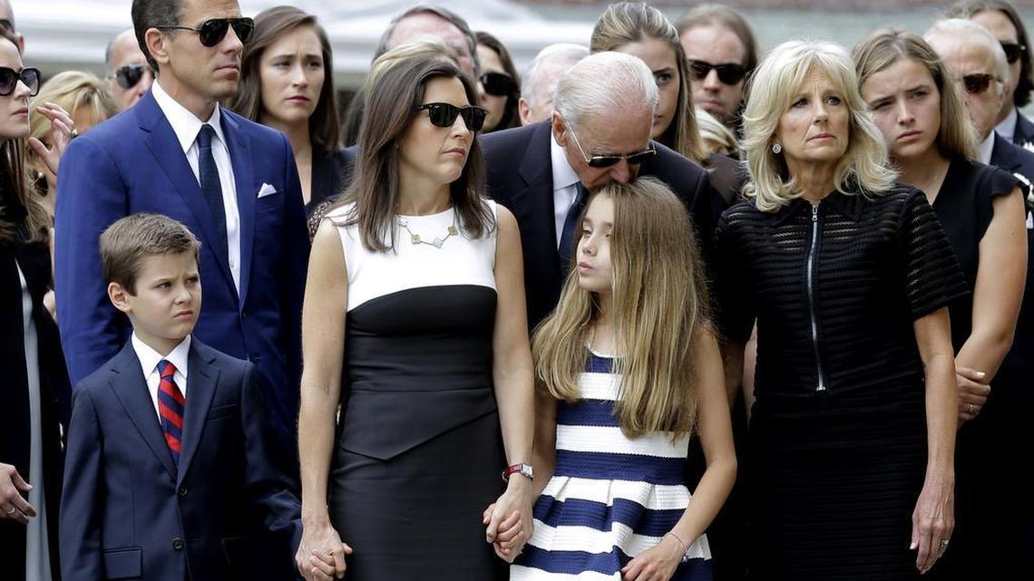Vice President Joe Biden kisses his granddaughter Natalie before a funeral for her father, former Delaware Attorney General Beau Biden, Saturday, June 6, 2015, at St. Anthony of Padua Roman Catholic Church in Wilmington, Del. Standing with the vice president are his grandson Hunter, from bottom left, son Hunter, daughter-in-law Hallie and wife Jill. Beau Biden, the eldest son of the vice president, died of brain cancer May 30 at age 46.