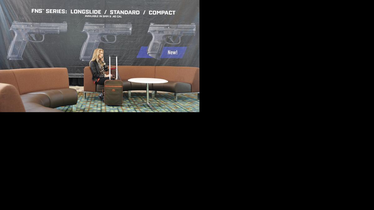 
Debbie Horn talks on the phone while attending the NRA Annual Meetings at the Music City Center in downtown Nashville, Tenn., Thursday, April 9, 2015. 
