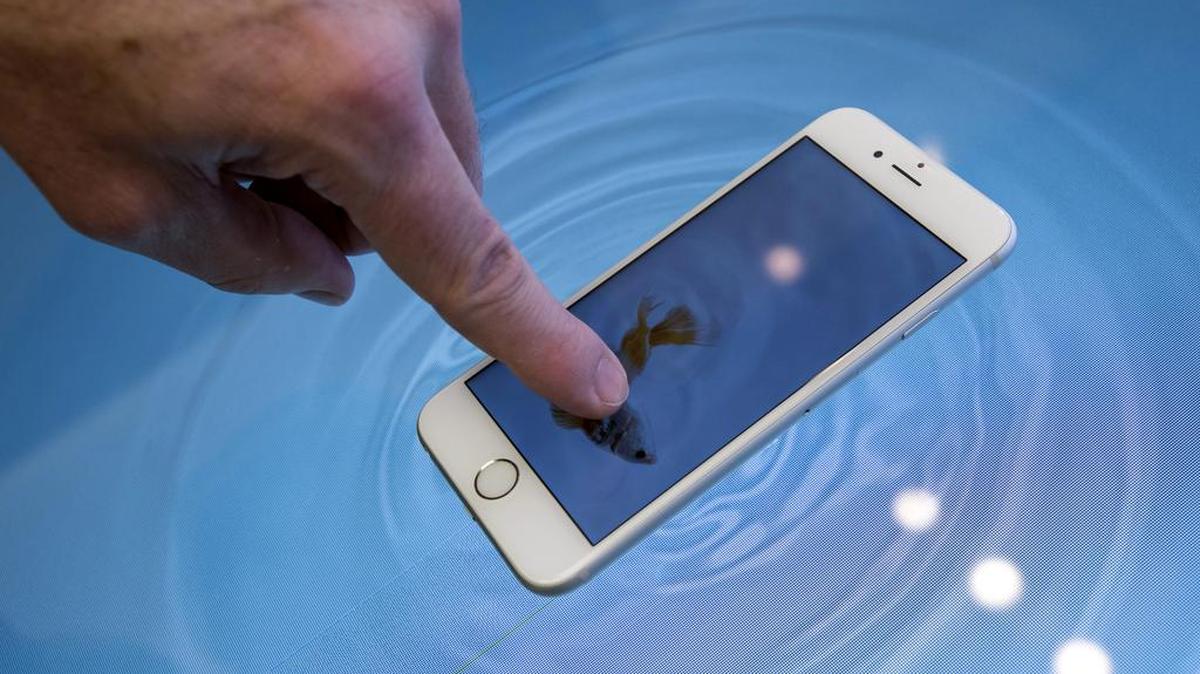 A customer tries the touch screen feature on the new Apple Inc.
