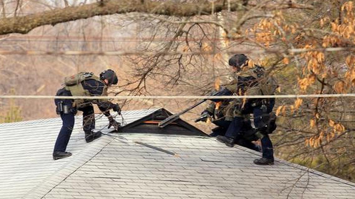 
St. Louis County SWAT team prepare to search the attic of a house in Ferguson, Mo., Thursday, March 12, 2015, following the midnight shooting of two police officers in Ferguson. There was no one in the attic. Two officers were shot in front of the Ferguson Police Department early Thursday while demonstrators were gathered across the street, an attack the county police chief described as “an ambush” that could easily have killed both men.
