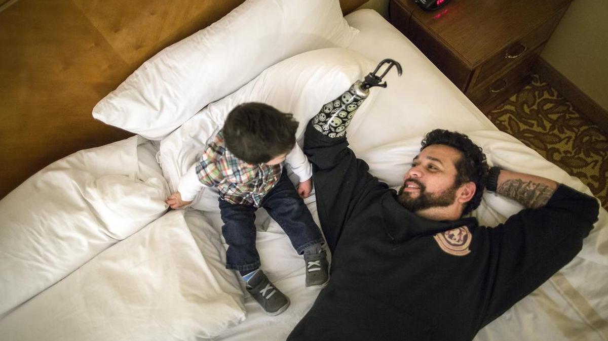 Jesse Longoria, a former Marine sniper who was fired from the Wounded Warrior Project shortly after his right arm was amputated in 2012 after complications from injuries sustained in Iraq, with his 16-month-old son, Noah, in Austin, Texas, Jan. 22, 2015. In its swift rise, the Wounded Warrior Project has also embraced aggressive styles of fund-raising, marketing and personnel management that have caused many current and former employees to question whether it has drifted from its original mission. “It got under my skin, started eating at me,” Longoria said of donations that came in. “I knew where the money was going to. It seemed to me like it was a big lie.”