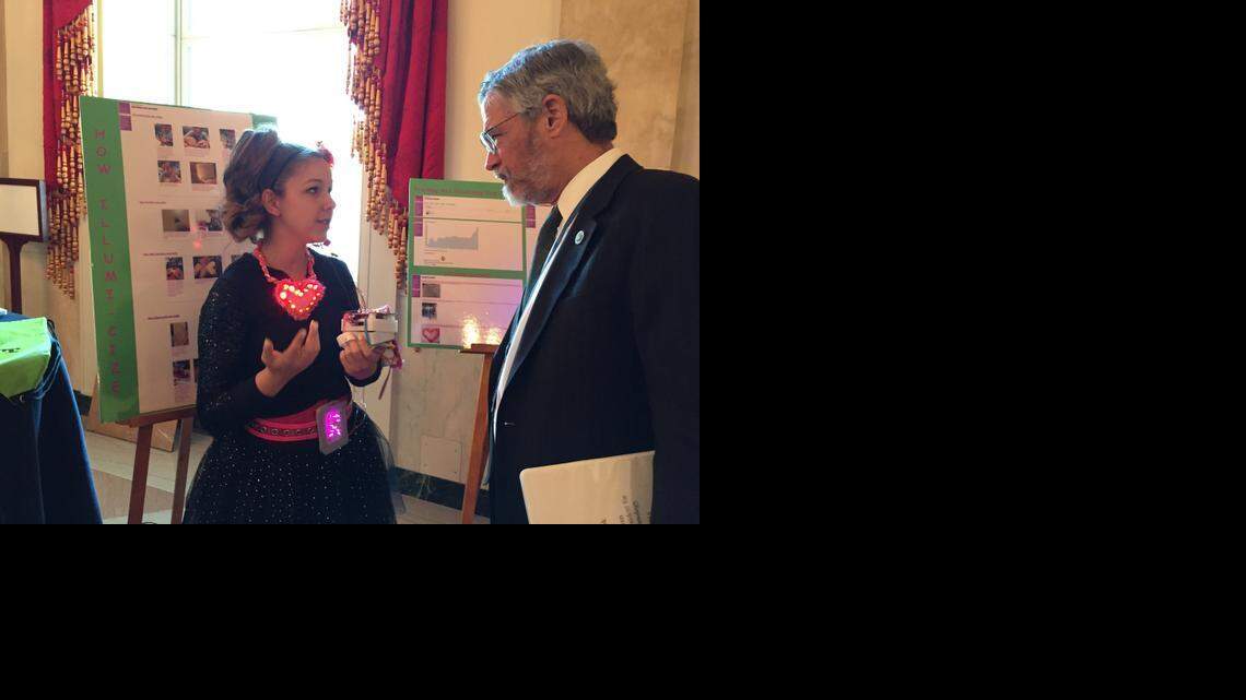 
Maureen Botros, 15, native of Wichita, Kansas, shows off her invention – a wearable heart-rate detector – at a science fair.
