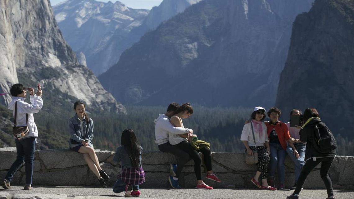 
Tourists stop to view the Yosemite Valley at Tunnel View on March 20, 2015, in Yosemite National Park, Calif. The surprising selection of a new concession operator at Yosemite National Park now faces scrutiny from lawmakers, local communities and, not least, park visitors.
