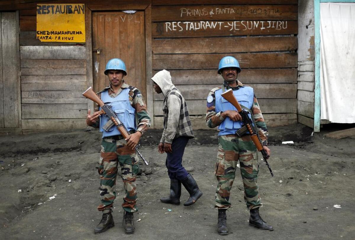 In this Friday Nov. 30, 2012 file photo, Two UN soldiers stand guard in Goma, Democratic Republic of Congo. Part of President Donald Trump's proposed deep budget cuts in foreign aid could be significant reductions in U.N. peacekeeping missions in some of the world's most dangerous places. On Thursday, April 6, 2017 the U.N. Security Council meets on the issue at the United States' request.