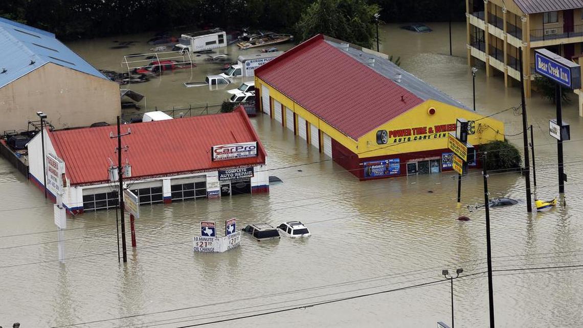 Businesses and cars are flooded near the Addicks Reservoir as floodwaters from Tropical Storm Harvey rise Tuesday, Aug. 29, 2017, in Houston.