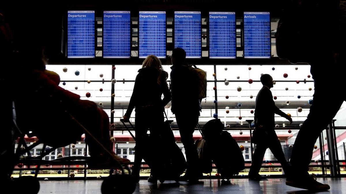 Travelers walk to their gates at O'Hare International Airport on Sunday, Nov. 29, 2015, in Chicago.