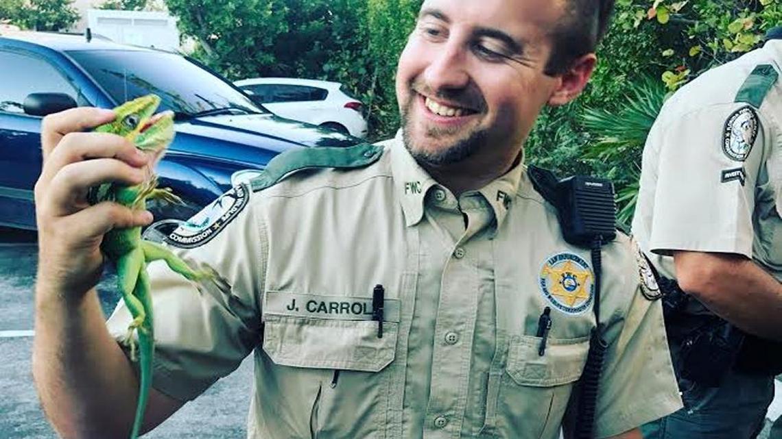 FWC Officer Jefferson Carroll holds one of the 114 reptiles recovered in a Wednesday traffic stop.
