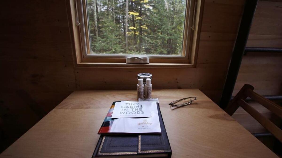 A guest register and information regarding property rentals are seen on a kitchen table at a tiny house in Croydon, N.H., on Tuesday, Oct. 20, 2015.