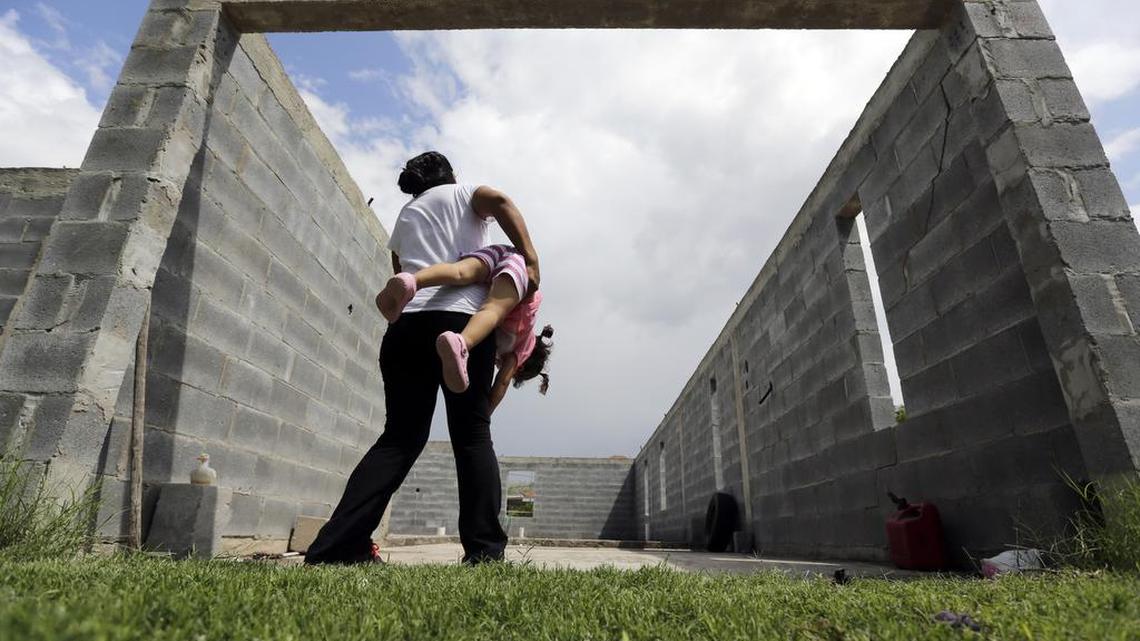 
A woman who is in the country illegally plays with her two-year-old daughter, who was born in the in the United States but was denied a birth certificate, in Sullivan City, Texas. A federal judge Friday declined to issue an emergency injunction forcing Texas officials to issue the birth certificates.
