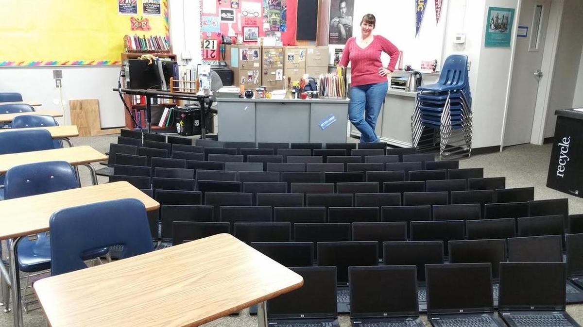 Teacher Kim Kutzner with some of the 90 laptops she has donated for students’ use at Chowchilla Union High School. District officials are questioning whether the computers are allowed in the classroom.