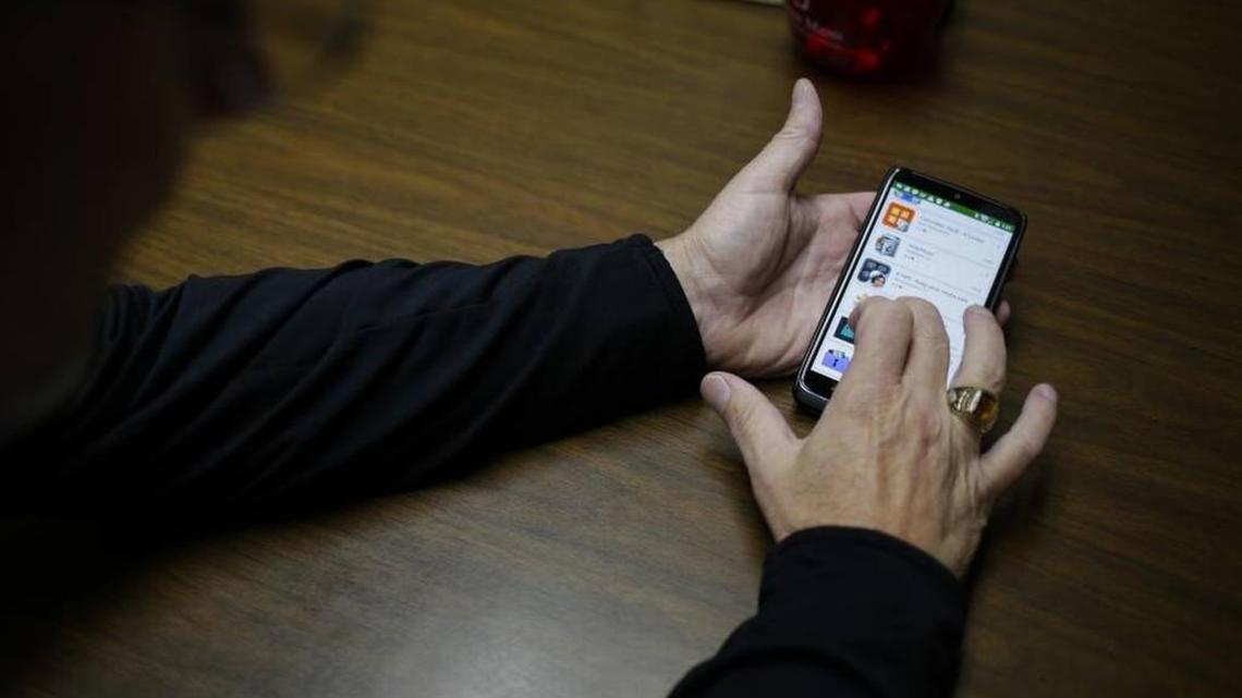 Bret Meuli, the principal at Canon City High School in Colorado, where more than 100 students at the high school were apparently exchanging nude pictures, calls up an app to show what students are using to hide photos on their cellphones, in Canon City, Colo., in November. Concerned by a practice he’s said is becoming more prevalent in schools, a California lawmaker is carrying a bill that would let schools suspend or expel kids for so-called sexting – sharing explicit pictures and recordings via electronic message.