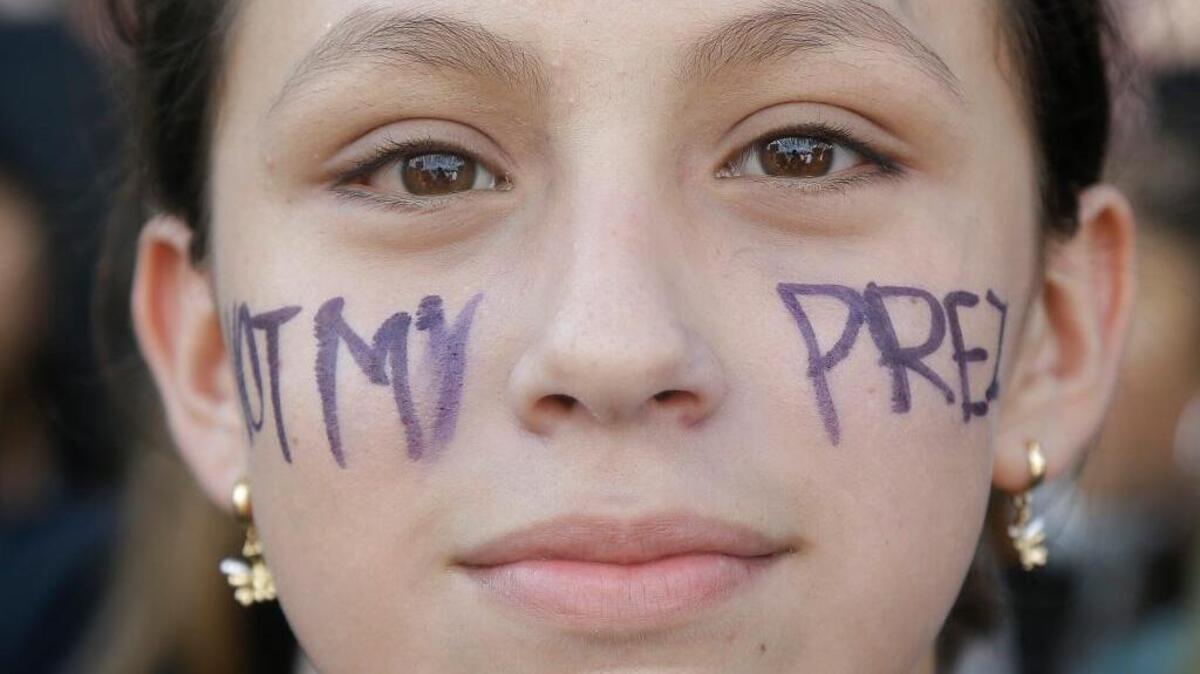 Lowell High School student Aracely Seminario poses for photos with the words “Not My Prez” on her face while protesting with other students in opposition of Donald Trump’s presidential election victory in front of City Hall in San Francisco, Thursday, Nov. 10, 2016.