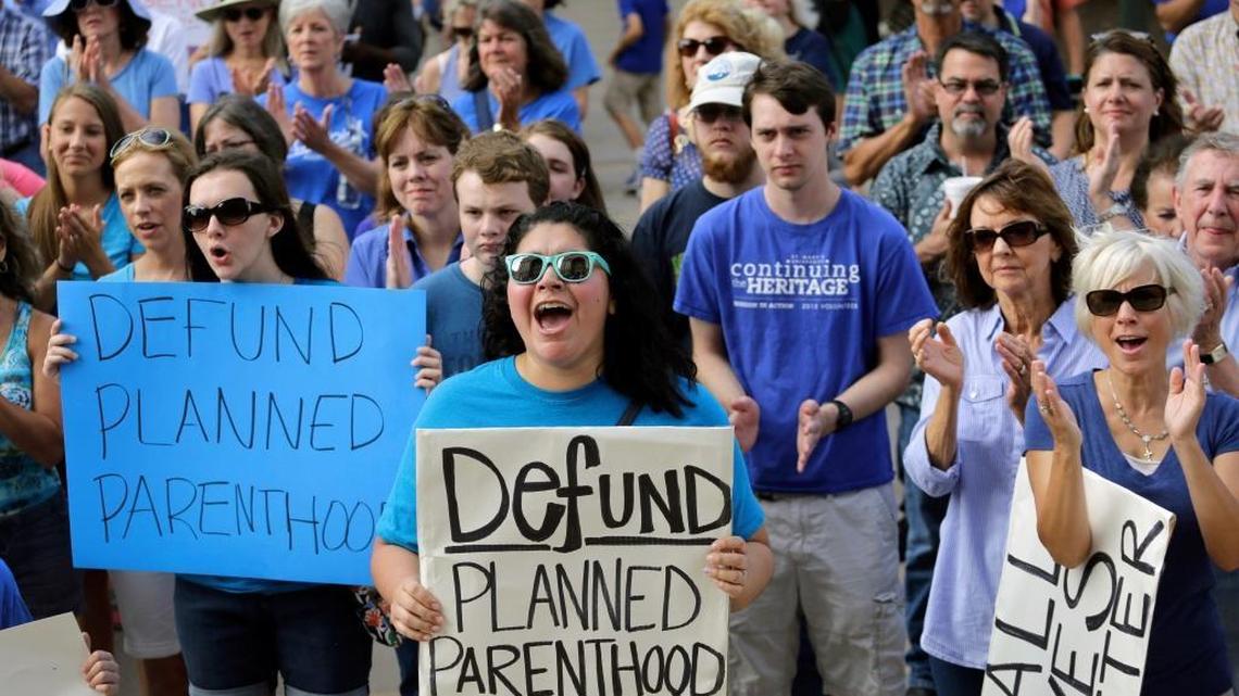 In this July 28, 2015, file photo, Erica Canaut, center, cheers as she and other anti-abortion rights activists rally on the steps of the Texas Capitol in Austin, Texas.