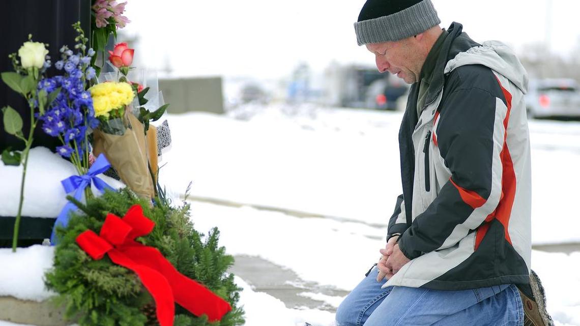 Roy Kieffer pauses after laying flowers Saturday, Nov. 28, 2015, in honor of the victims of Friday’s deadly shooting at a Planned Parenthood clinic in Colorado Springs, Colo.