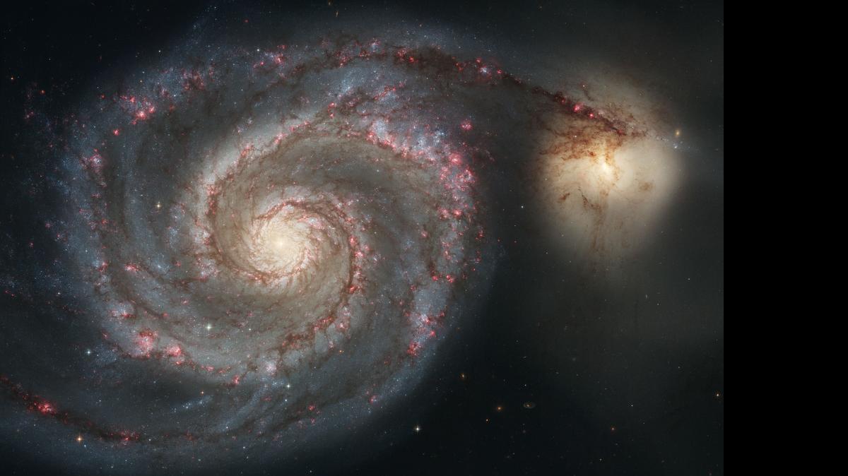 
This January 2005 image made by the NASA/ESA Hubble Space Telescope shows the Whirlpool Galaxy (M51) and a companion galaxy. The Whirlpool's two curving arms are star-formation factories, compressing hydrogen gas and creating clusters of new stars. The Hubble Space Telescope marks its 25th anniversary. A full decade in the making, Hubble rocketed into orbit on April 24, 1990, aboard space shuttle Discovery. 
